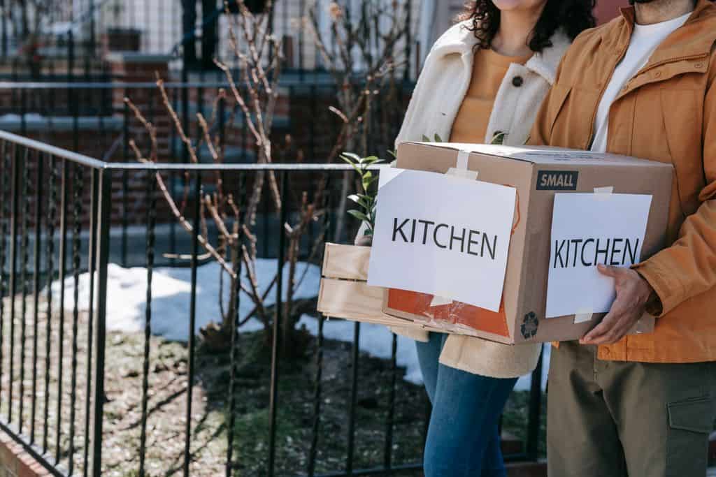 team carrying labelled boxes